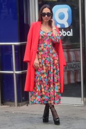 Myleene Klass in a Bright Floral Dress and Red Coat and Towering Heals - London 01/28/2023