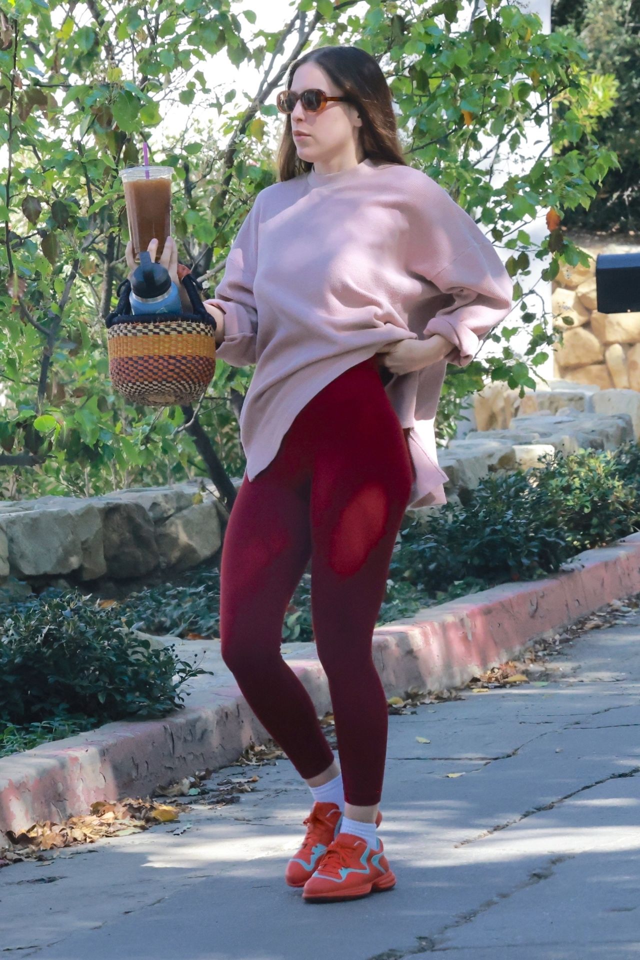 Scout Willis Wearing an Oversized Blush Sweater and Red Leggings - Los