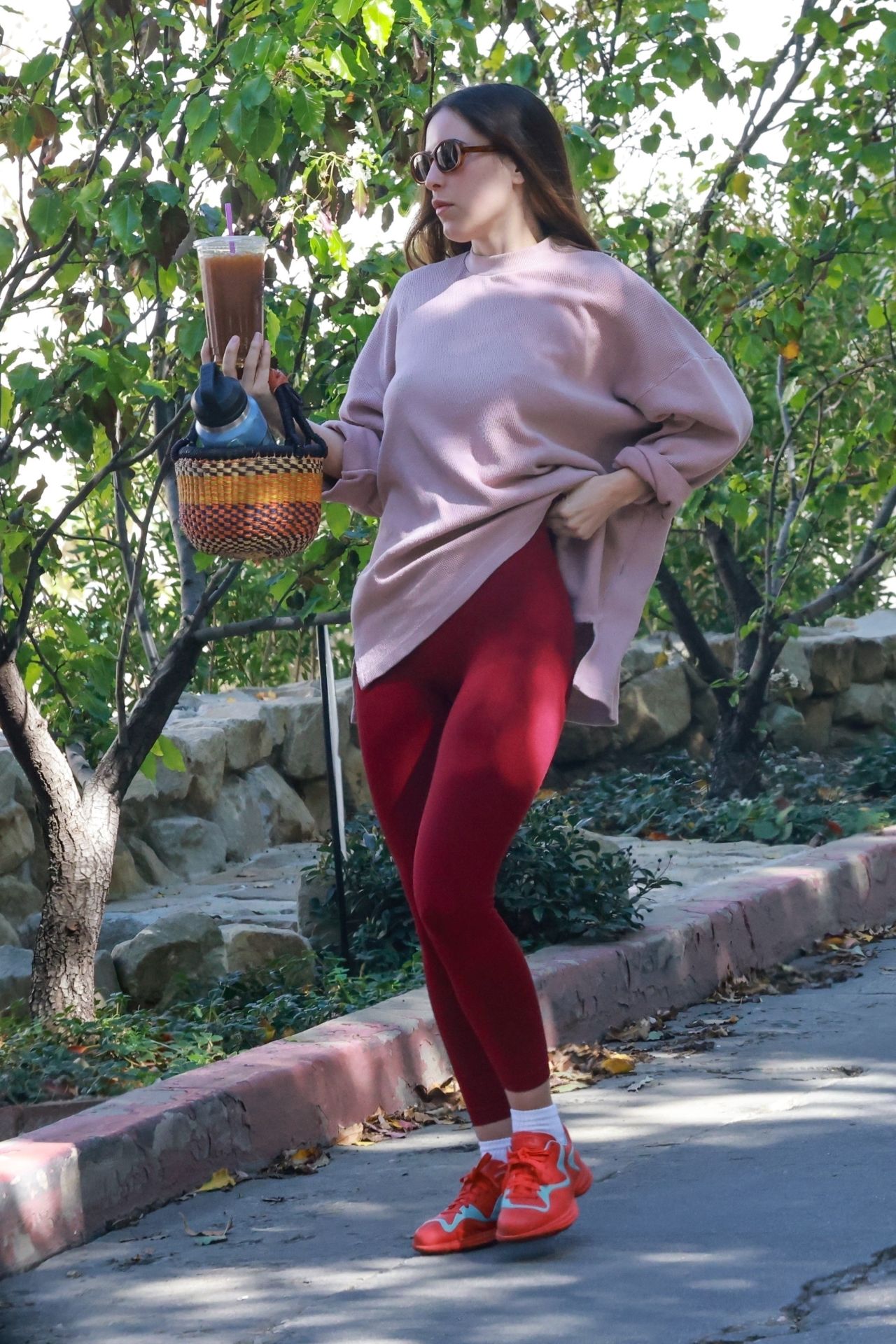 Scout Willis Wearing an Oversized Blush Sweater and Red Leggings - Los