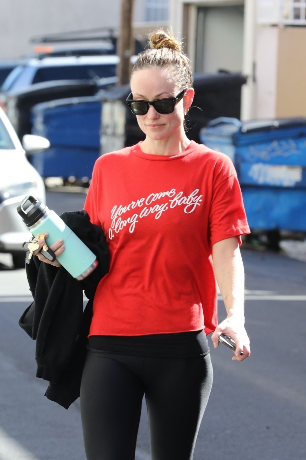 Olivia Wilde Wearing a Red Top, Black Yoga Pants and Sunglasses in
