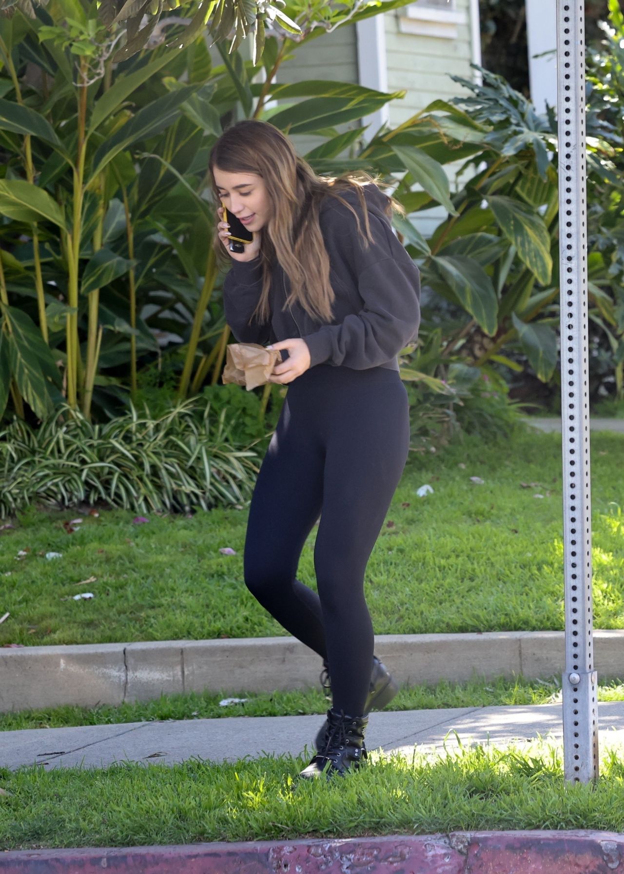Caylee Cowan dons a black crop top and leggings while out shopping