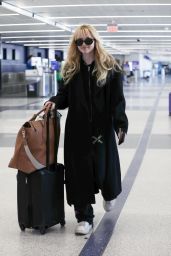 Kathryn Newton in a Black Coat and Sunglasses at LAX in Los Angeles 04/03/2023