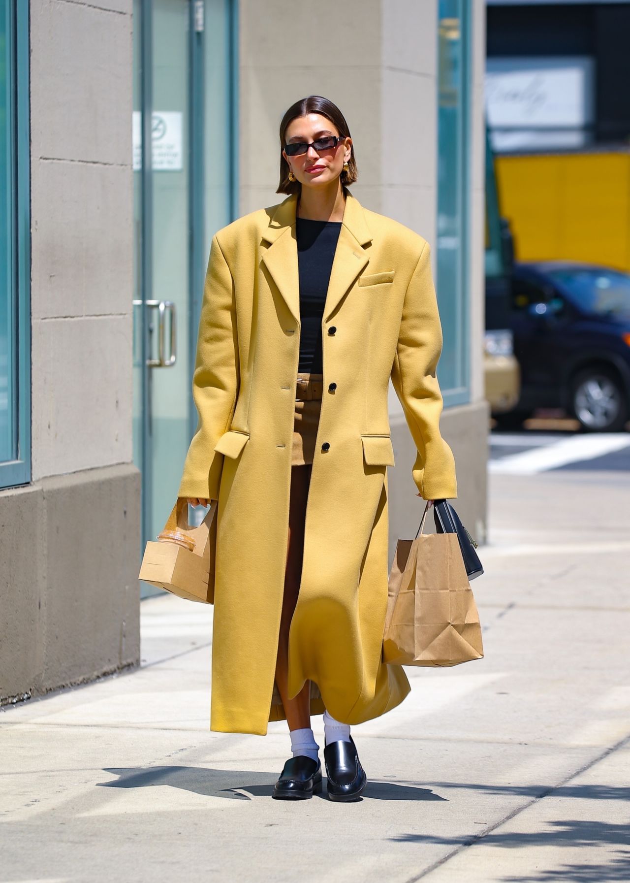 Hailey Rhode Bieber in a Yellow Trench Coat in New York 05/10/2023 ...