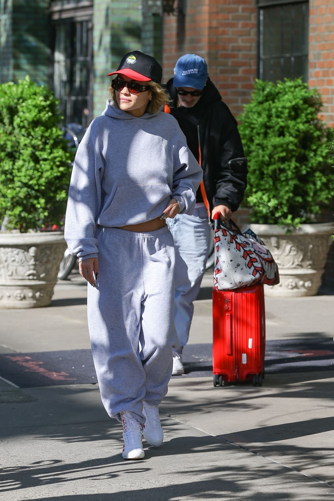 Rita Ora in a Grey Sweater, Grey Sweatpants, Red and White Sneakers and ...