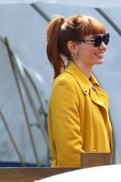 Eleanor Tomlinson in a Bright Yellow Coat at "The Outlaws" Set in Bristol 06/12/2023