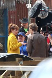 Eleanor Tomlinson in a Bright Yellow Coat at "The Outlaws" Set in Bristol 06/12/2023