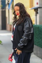 Rihanna in Varsity Jacket, Puma Sneakers and a Bright Red Louis Vuitton Bag in Los Angeles 06/16/2023