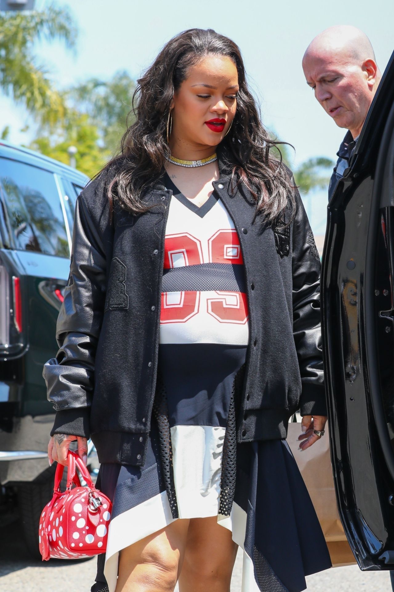 Rihanna in Varsity Jacket, Puma Sneakers and a Bright Red Louis Vuitton Bag  in Los Angeles 06/16/2023 • CelebMafia