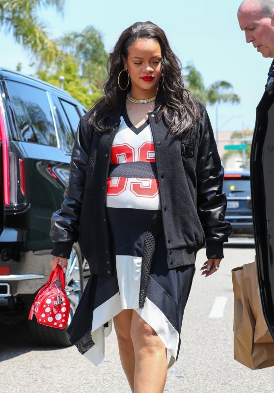 Rihanna in Varsity Jacket, Puma Sneakers and a Bright Red Louis Vuitton Bag in Los Angeles 06/16/2023