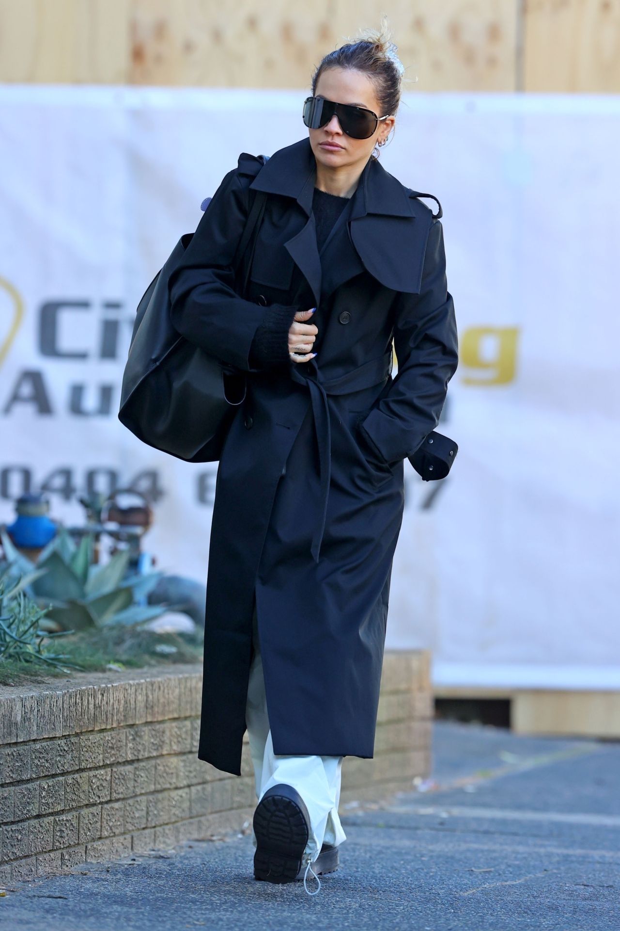Rita Ora Wearing a Black Trench Coat in Sydney 06/20/2023 • CelebMafia