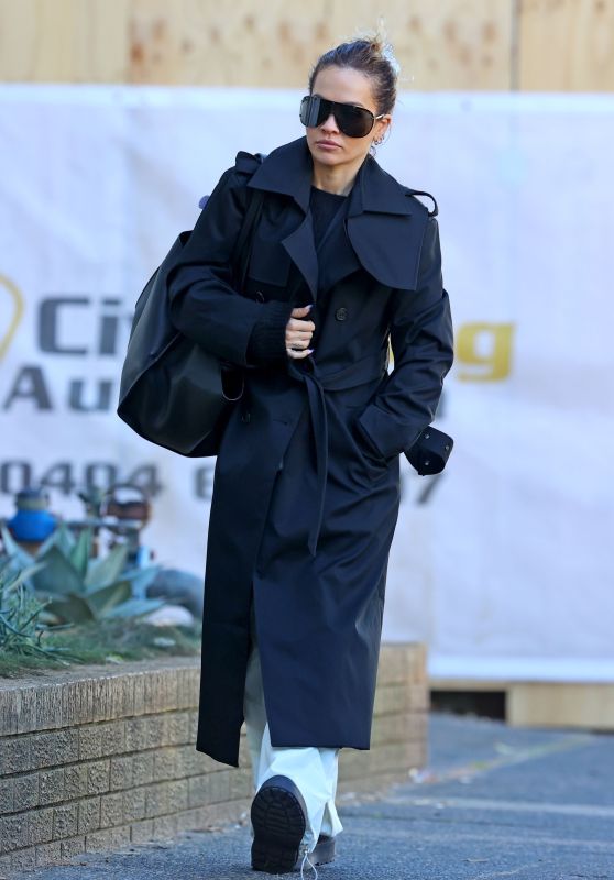 Rita Ora Wearing a Black Trench Coat in Sydney 06/20/2023