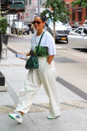 Tracee Ellis Ross in White Pants and a Green Bottega Veneta Purse ...