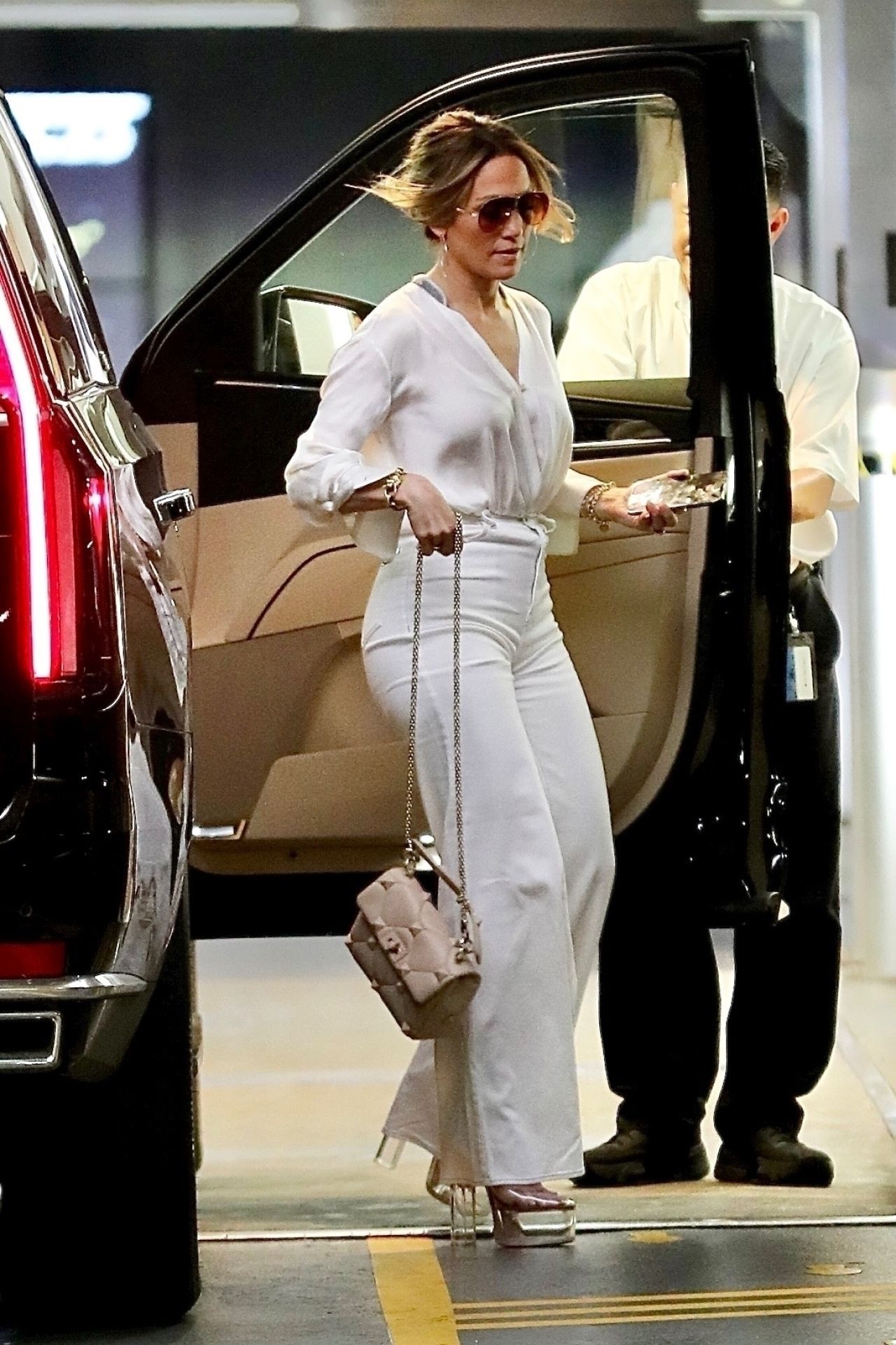 Jennifer Lopez in a White Trousers With a Tucked in Blouse While ...