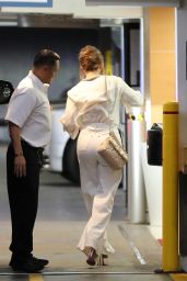 Jennifer Lopez in a White Trousers With a Tucked in Blouse While Carrying Valentino Handbag in Beverly Hills 07/20/2023