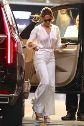 Jennifer Lopez in a White Trousers With a Tucked in Blouse While Carrying Valentino Handbag in Beverly Hills 07/20/2023