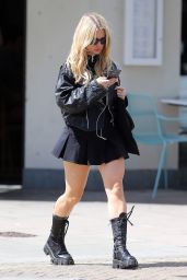 Lottie Moss Wearing Black Leather Bikers Jacket, Buckle Neck Top, Short Skirt and Boots - London 07/17/2023