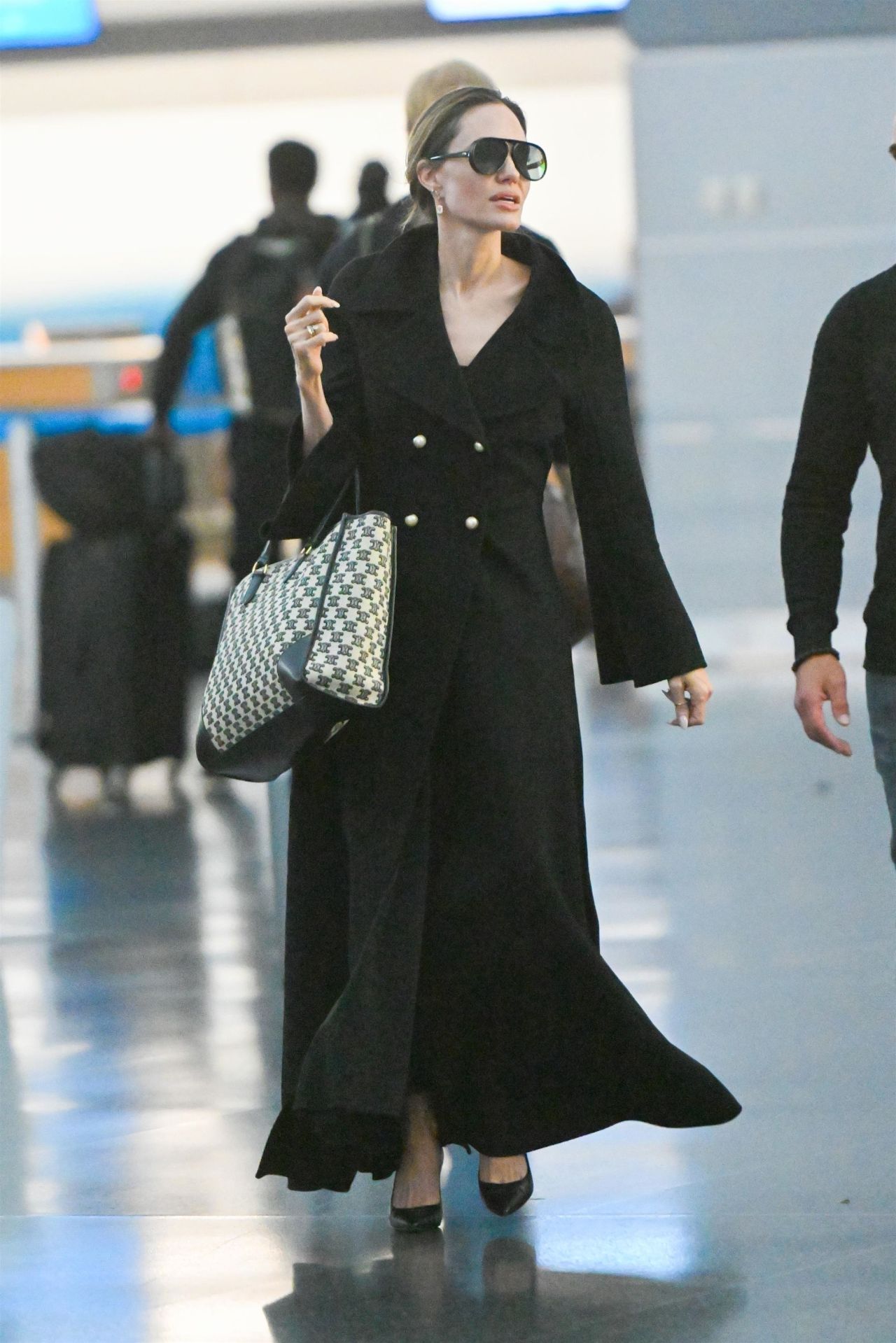 Angelina Jolie Wore a Dior Handbag With a Black Disposable Face Mask