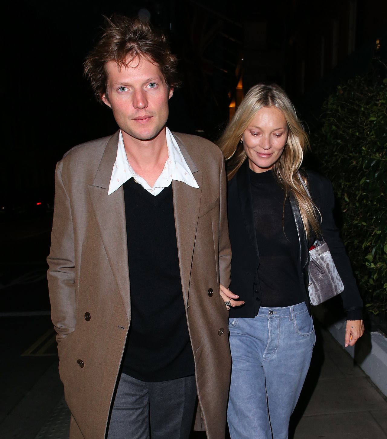 Kate Moss Wearing a Short Black Blazer, Shear Top, Jeans and Boots