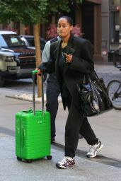 Tracee Ellis Ross in a Black Outfit and Green Luggage in New York 09/19/2023