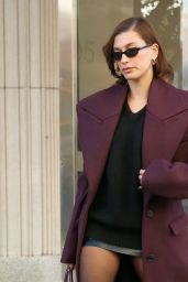 Hailey Rhode Bieber in a Burgundy Coat, Leather Mini Skirt, Black Sweater and Large Leather Duffle Bag in New York City 11/19/2023