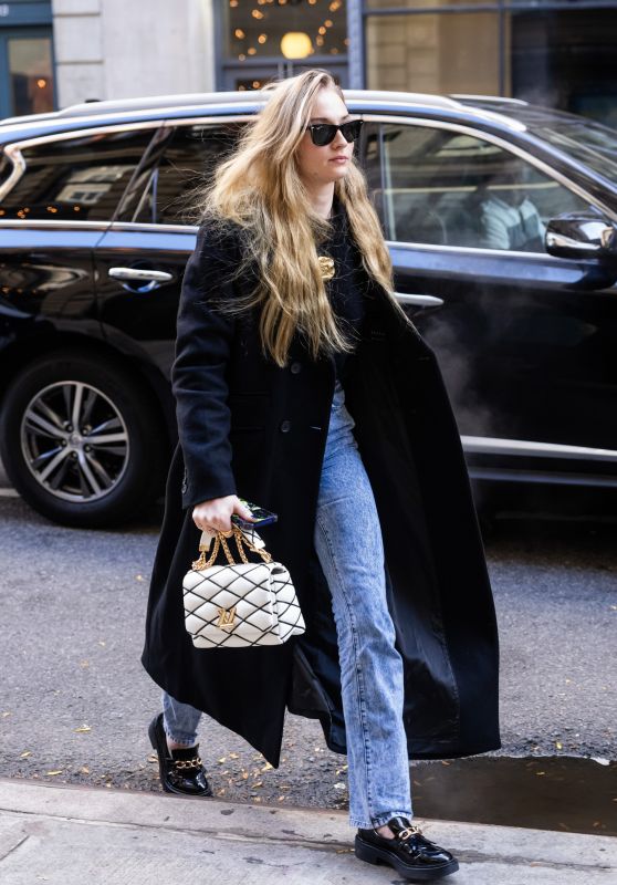 Sophie Turner in a Black Trench Coat, Matching Blouse, Jeans and Black Loafers in NY 11/02/2023