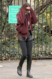 Irina Shayk Wears Black Leather Hot Pants, Black Stockings, Black Boots and Maroon Jacket in NYC 12/04/2023