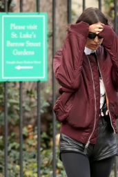 Irina Shayk Wears Black Leather Hot Pants, Black Stockings, Black Boots and Maroon Jacket in NYC 12/04/2023