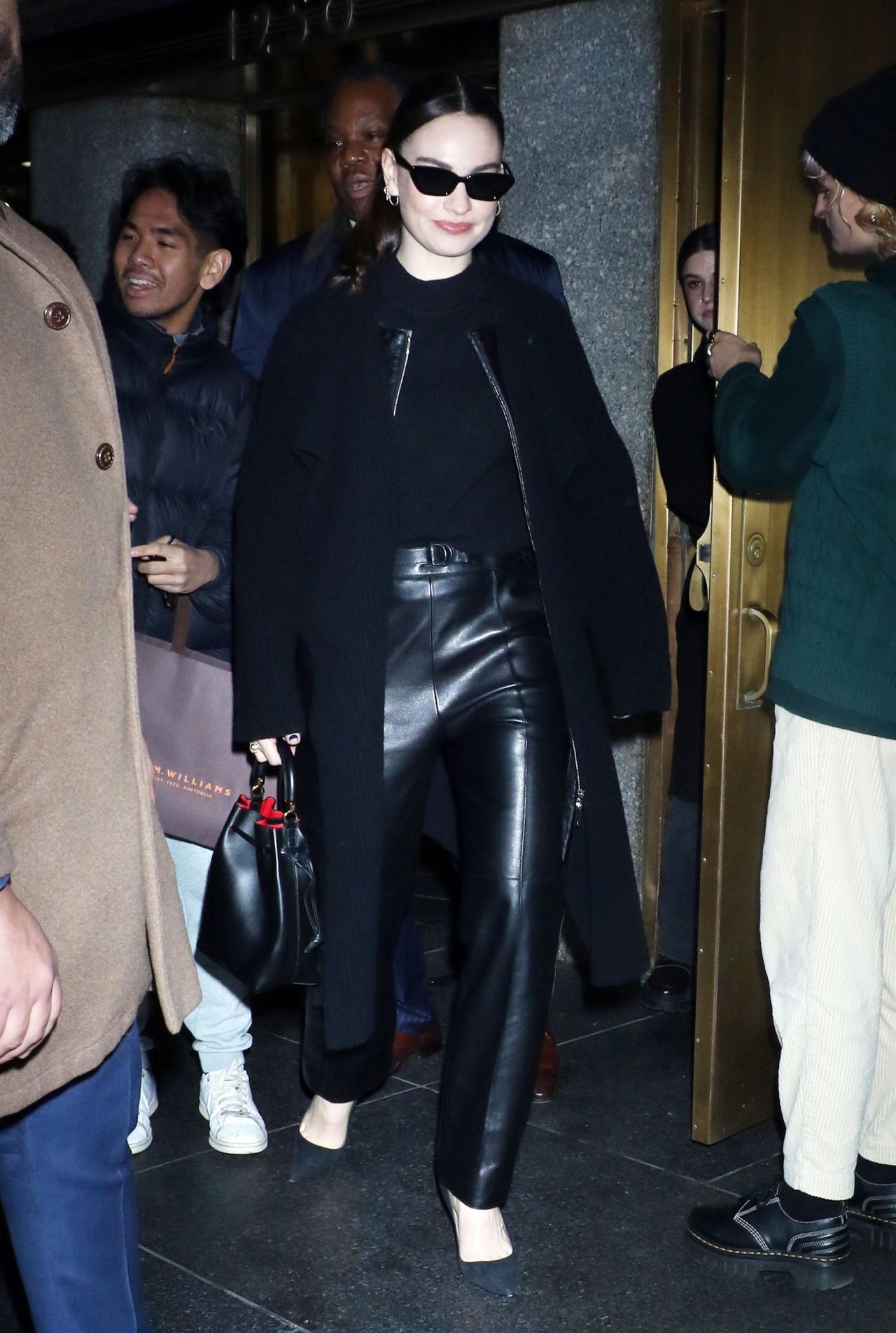 Lily James in Black Leather and a Long Black Overcoat at The Kelly