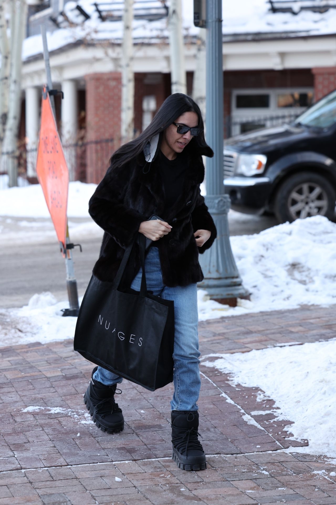 Noor Alfallah in a Fur Jacket, Jeans and Prada Boots - Shopping in