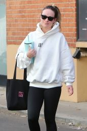 Olivia Wilde in Cream Hoodie, Black Leggings and Sunglasses in Los Angeles 12/11/2023