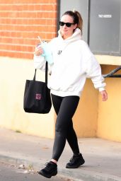 Olivia Wilde in Cream Hoodie, Black Leggings and Sunglasses in Los Angeles 12/11/2023