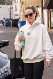 Olivia Wilde in Cream Hoodie, Black Leggings and Sunglasses in Los Angeles 12/11/2023