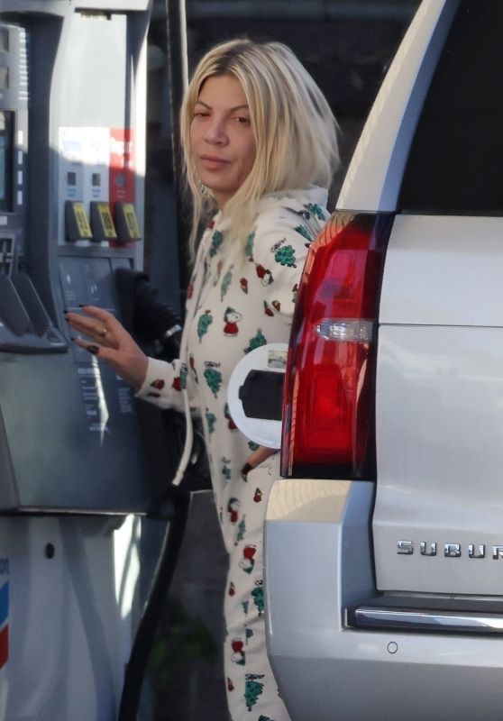 Tori Spelling in a Snoopy-themed Christmas Onesie - Pumping Gas in Woodland Hills 12/15/2023