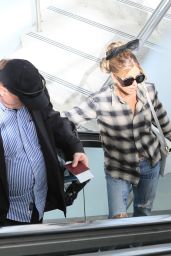 Kate Beckinsale "Wore a black and white flannel and oversized hair bow to the airport paired with white platform sneakers in Los Angeles" (27.01.2024) 24x