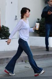 Milla Jovovich in a Distressed White Top Paired With Some Flared Blue Jeans in Los Angeles 01/13/2024