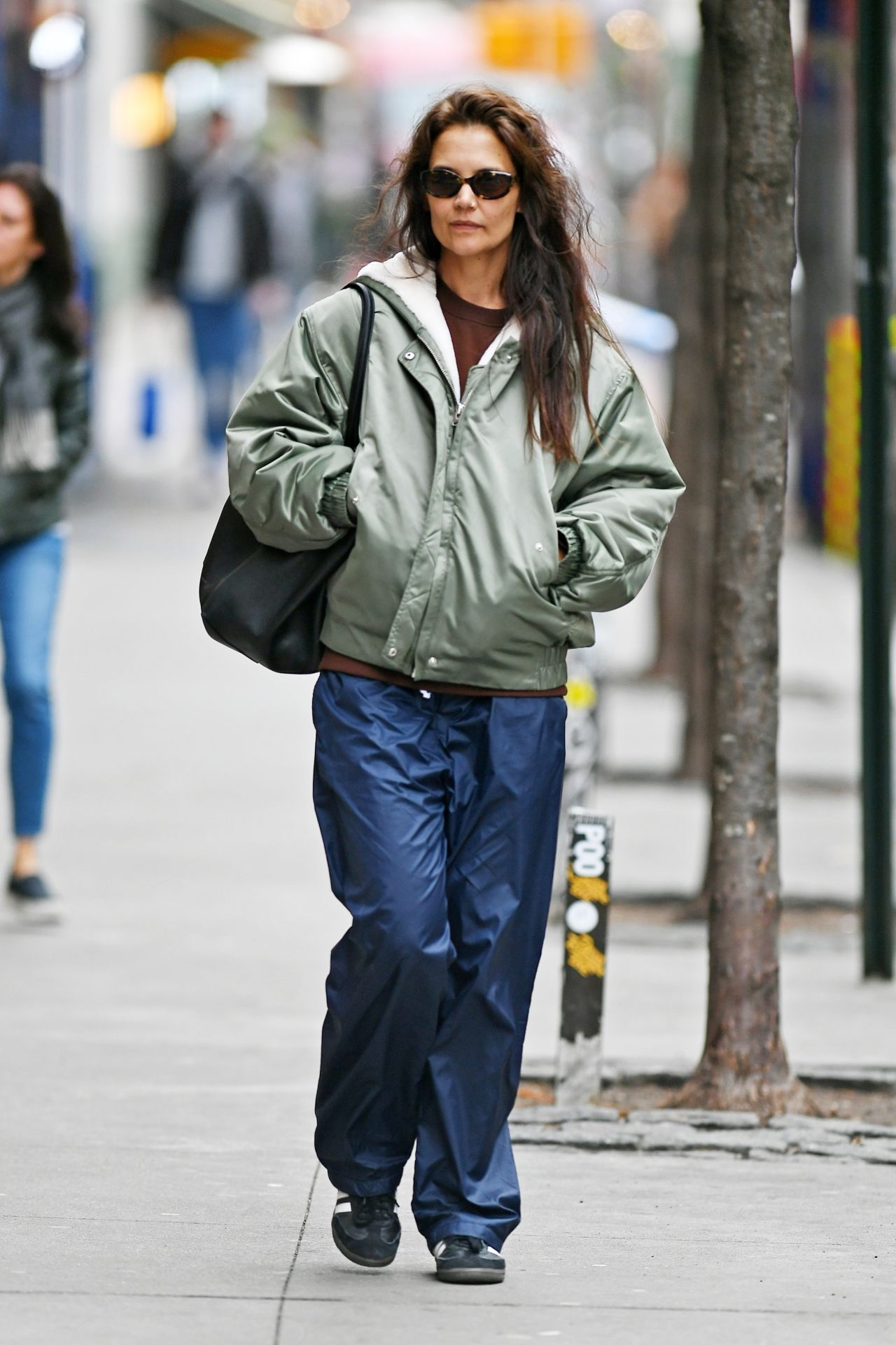 Katie Holmes in a Green Olive Rain Jacket and Navy Blue Rain Pants