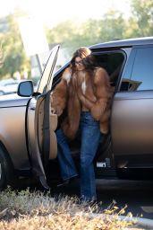 Kylie Jenner in a Large Fur and Jeans Exits a Calabasas Office Building 02/14/2024