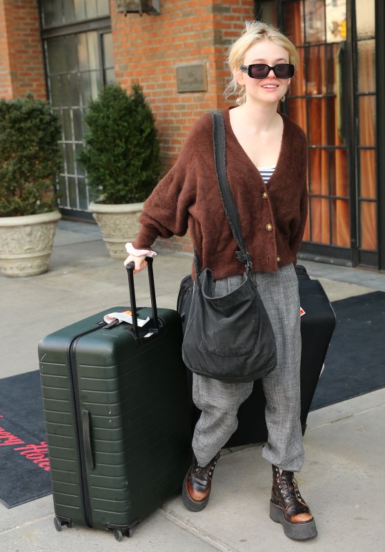 Emily Alyn Lind in a Rust Cardigan, Gray Pants and Lace-up Boots in New York 03/18/2024