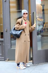 Katie Holmes in a Camel Coat, a Grey Beanie, and Pony Brand Sneakers in SoHo, New York 03/22/2024