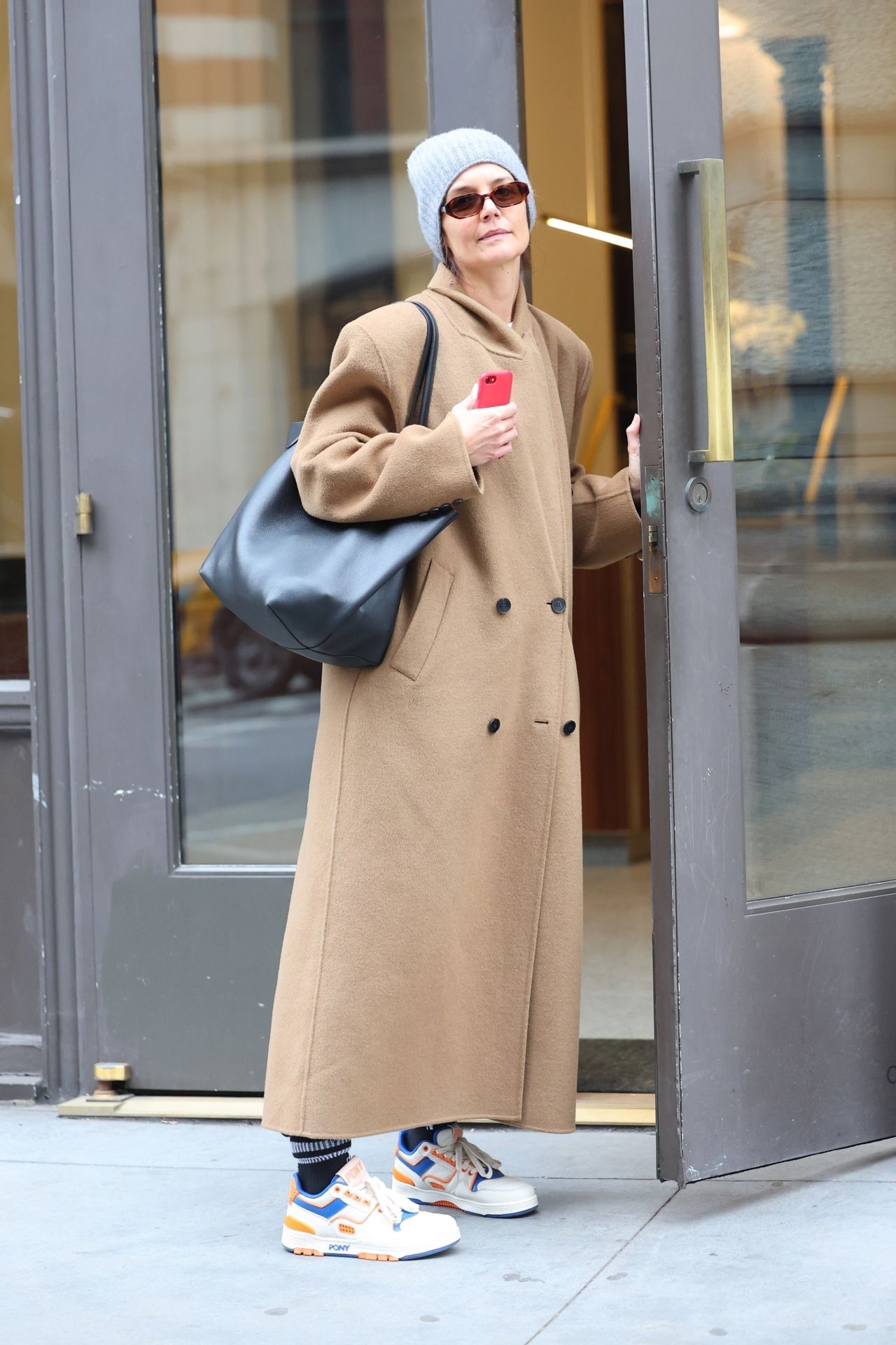 Katie Holmes in a Camel Coat, a Grey Beanie, and Pony Brand Sneakers in ...