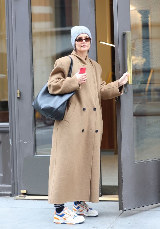 Katie Holmes in a Camel Coat, a Grey Beanie, and Pony Brand Sneakers in SoHo, New York 03/22/2024