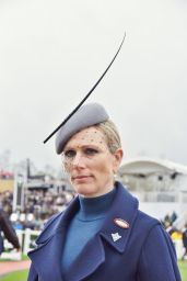 Zara Tindall Wearing a Long Blue Coat and a Gray and Extravagant Hat on Day One of the Cheltenham Race Festival 03/12/2024