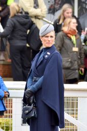 Zara Tindall Wearing a Long Blue Coat and a Gray and Extravagant Hat on Day One of the Cheltenham Race Festival 03/12/2024