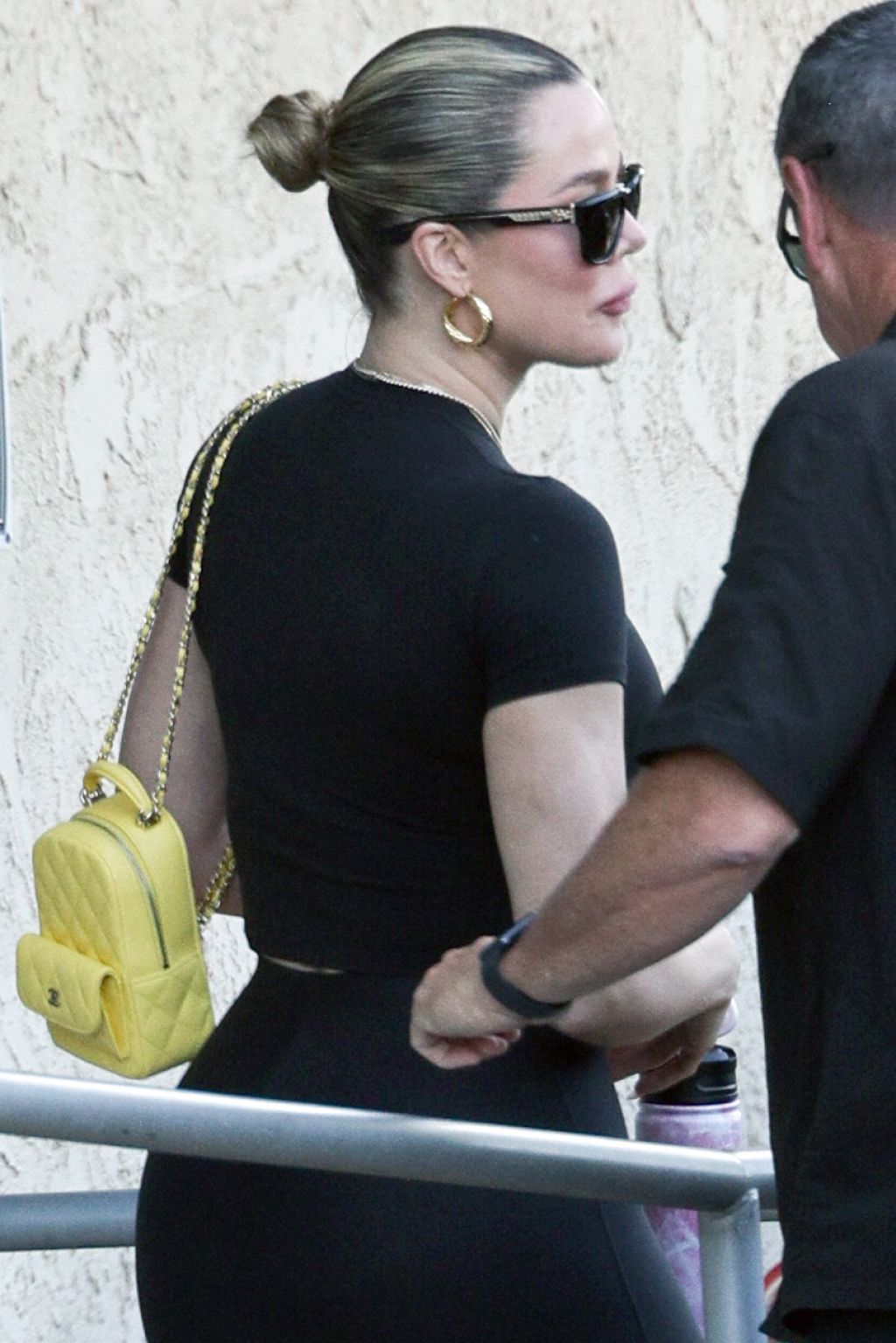Khloe Kardashian in a Black Matching Outfit With a Yellow Mini Chanel ...