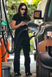 Noor Alfallah in All Black While Stopping to Refuel Her Land Rover Defender in Los Angeles 05-29-2024