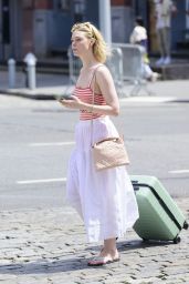 Elle Fanning Carrying a Suitcase and Wearing a Christian Dior Top in Soho  06-04-2024