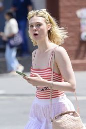 Elle Fanning Carrying a Suitcase and Wearing a Christian Dior Top in Soho  06-04-2024