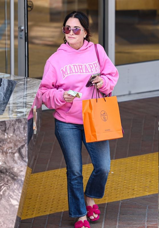 Kyle Richards in a Bright Pink Hoodie and Matching Purse and Slippers Shopping at Neiman Marcus in Beverly Hills 06-13-2024