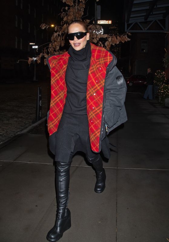 Rita Ora dazzles in NYC with a chic black coat and boots, set to co-host NYE with Ryan Seacrest.