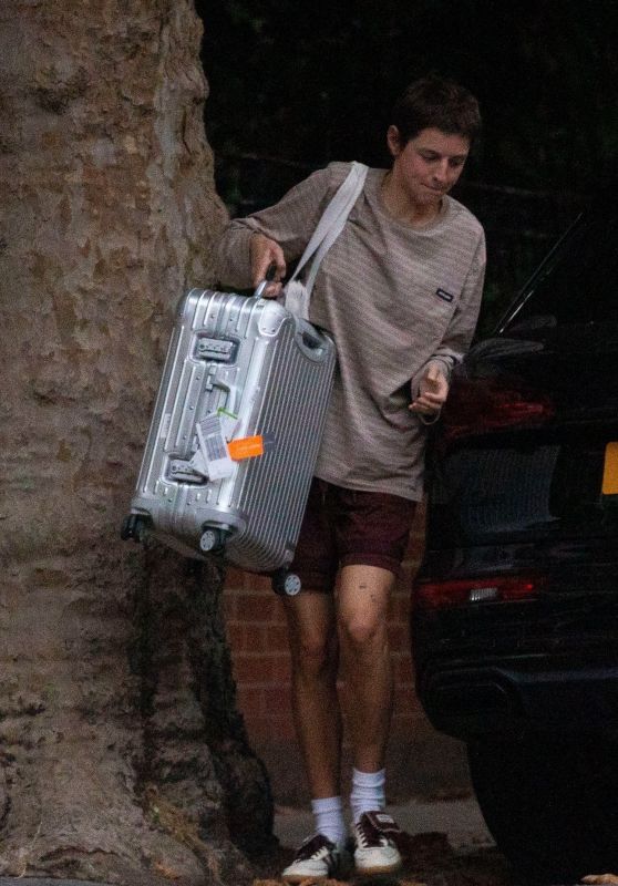 Emma Corrin Carries Luggage, Not Gossip
